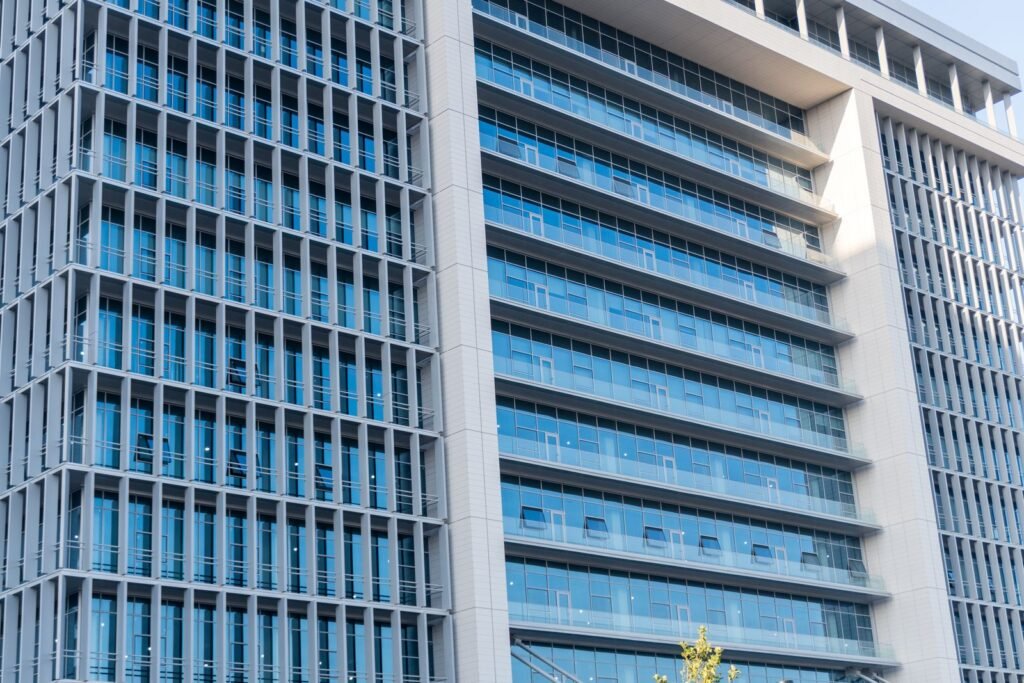 Modern glass-facade commercial office building exterior, representing UAE commercial and SME property financing