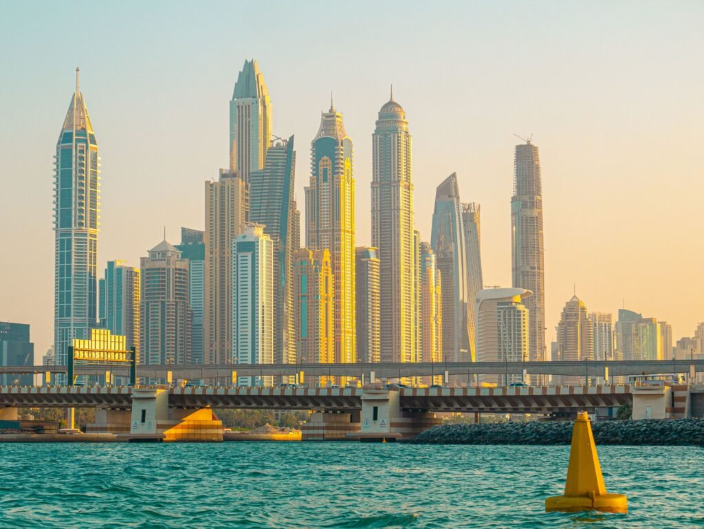 Dubai Marina skyscraper skyline at sunset, viewed across the water, illustrating the Dubai property market UK expat buyers finance with a mortgage