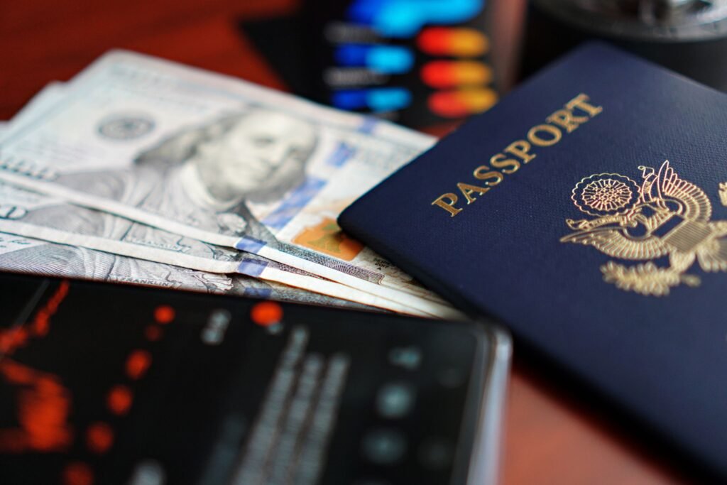 US passport and US dollar cash beside a smartphone, representing a US citizen preparing to apply for a Dubai mortgage