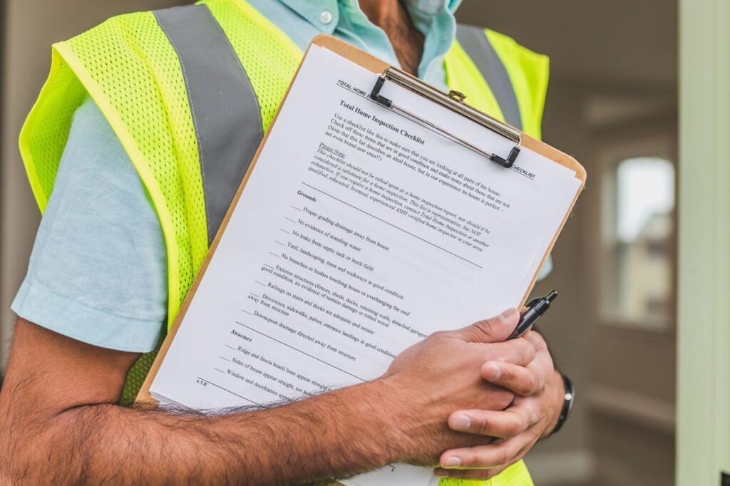 Home inspector reviewing a property valuation checklist on a clipboard