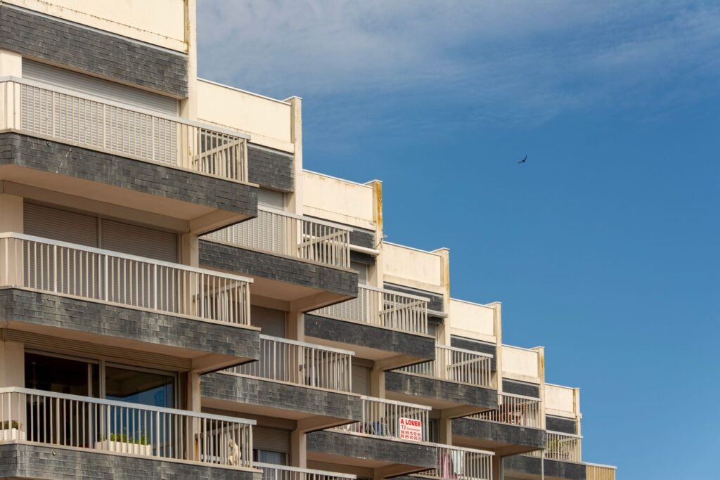Modern apartment building with balconies against a clear blue sky, representing a UAE buy-to-let investment property