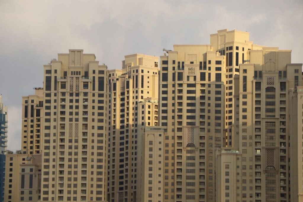 Modern high-rise residential towers in Dubai Marina at golden hour, the kind of freehold property Indian expat and NRI buyers finance with a Dubai mortgage