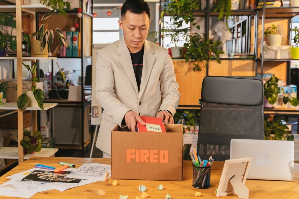 Stressed professional reviewing paperwork after job loss, weighing the impact on mortgage payments in the UAE