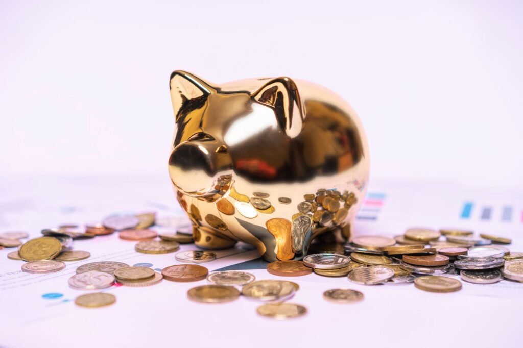Golden piggy bank surrounded by coins on top of financial documents, representing a lump-sum partial prepayment that saves interest on a UAE mortgage